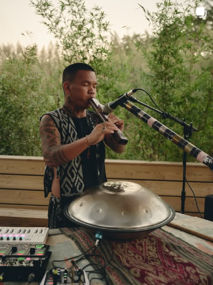 A musician playing outdoors at ATMOS, from the ATMOS Instagram feed